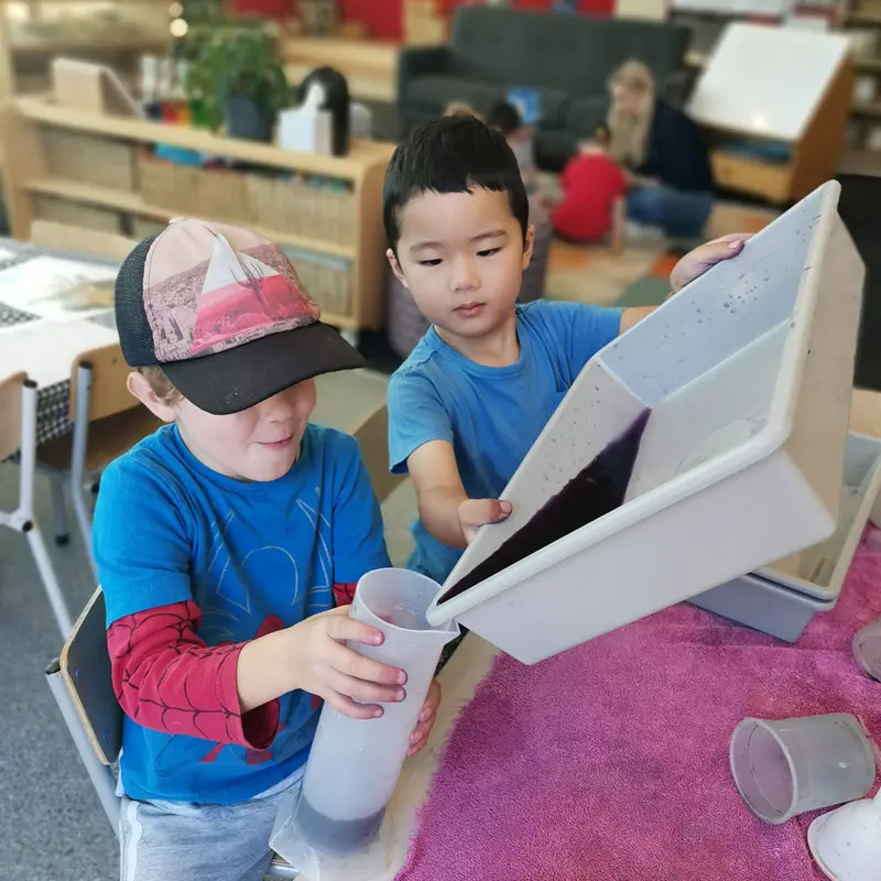 boys work together to collect dye