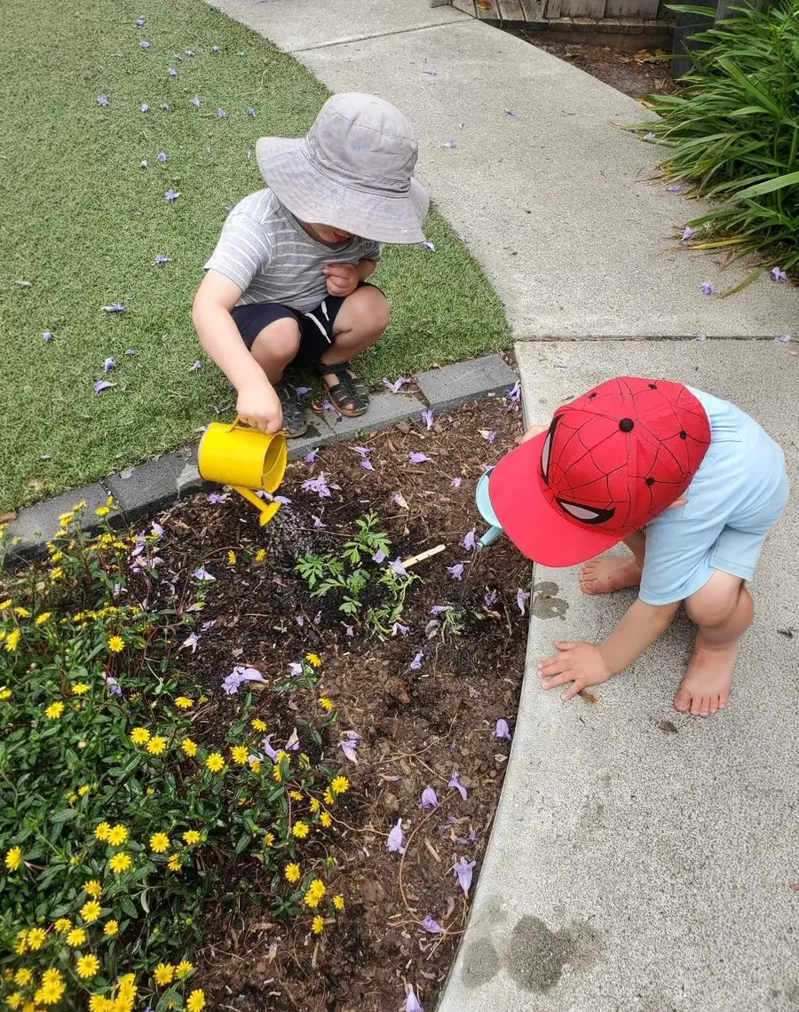 boys helping gardening at Preschool wide