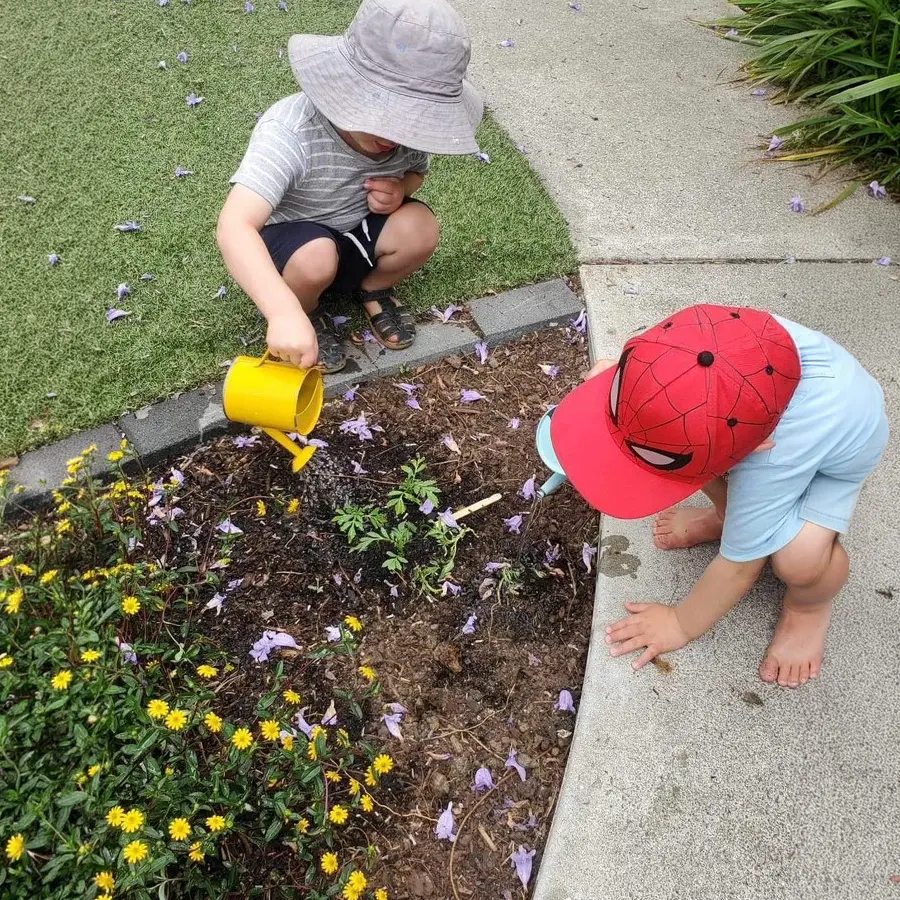 boys helping gardening at Preschool wide