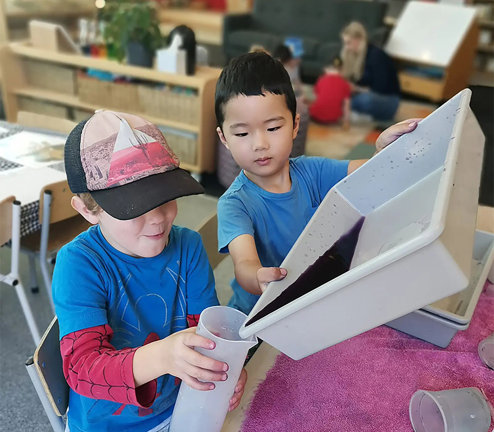 boys work together to collect dye box