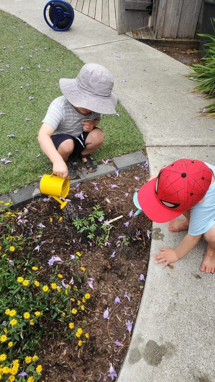 boys helping gardening at Preschool